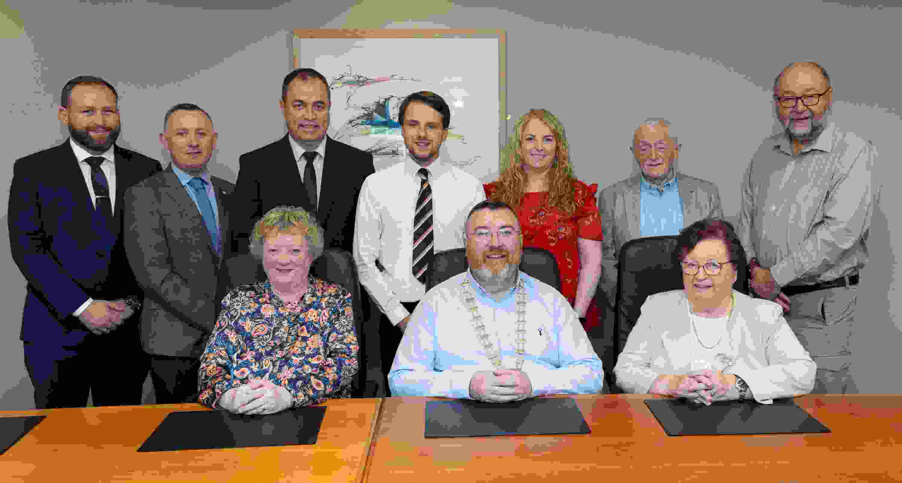 Image of the People First Credit Union board of directors with three people sitting down and seven people standing behind them.